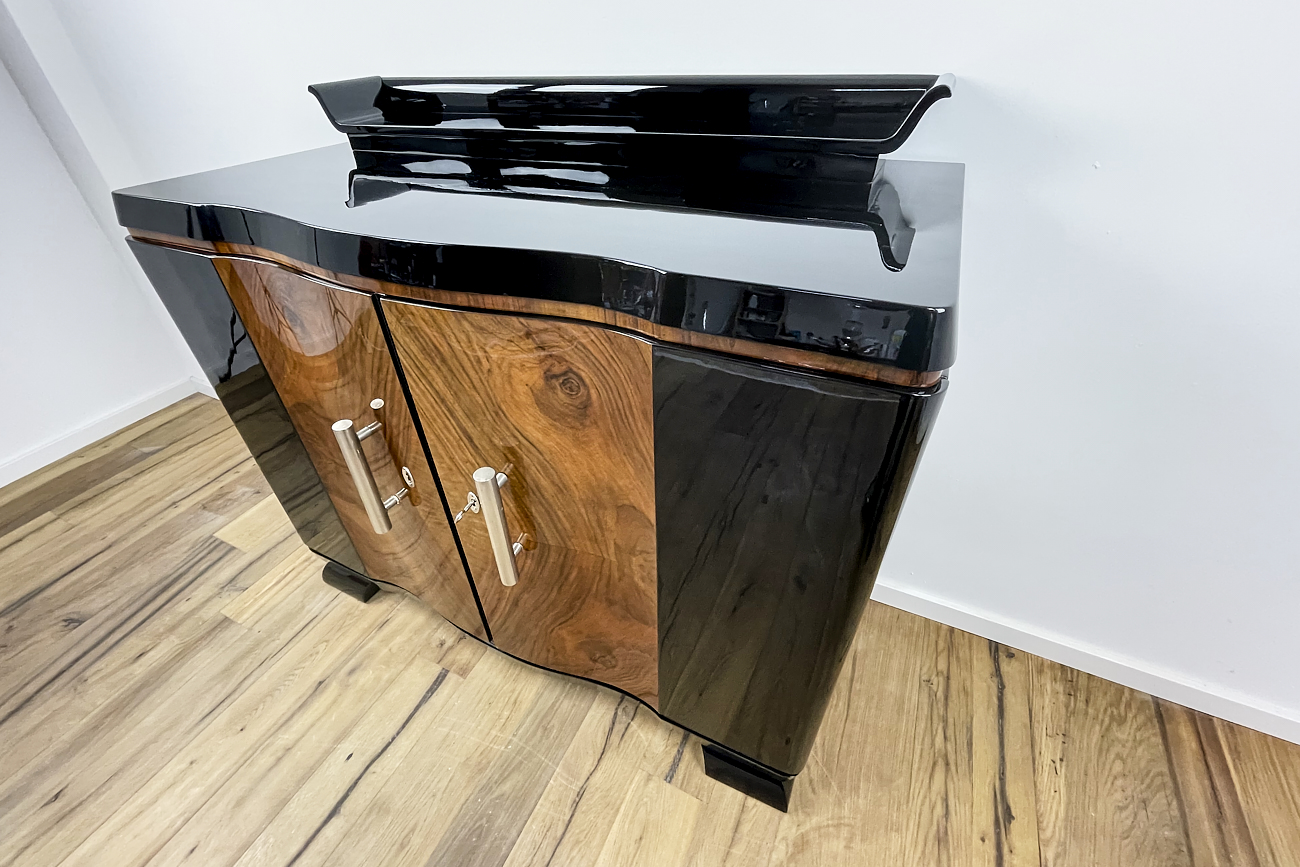 Art Deco chest of drawers from Germany around 1930 in black high gloss and walnut